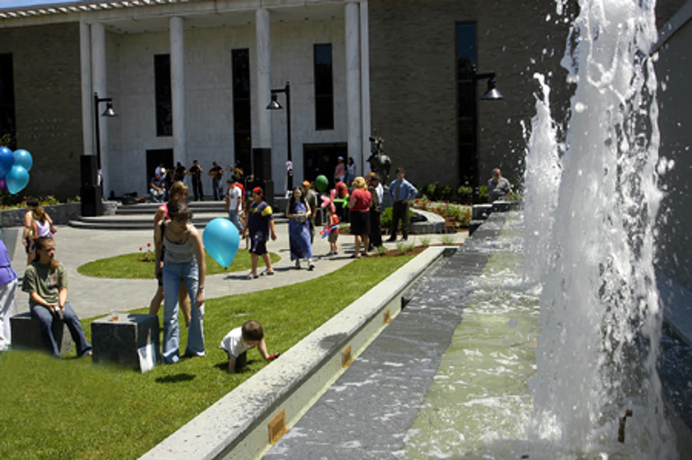 Renovated Danbury Library Plaza with seating, gardens, and the Sybil Ludington sculpture along Main Street